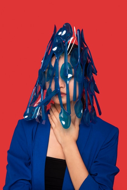 Free Photo asian woman being covered in plastic tableware