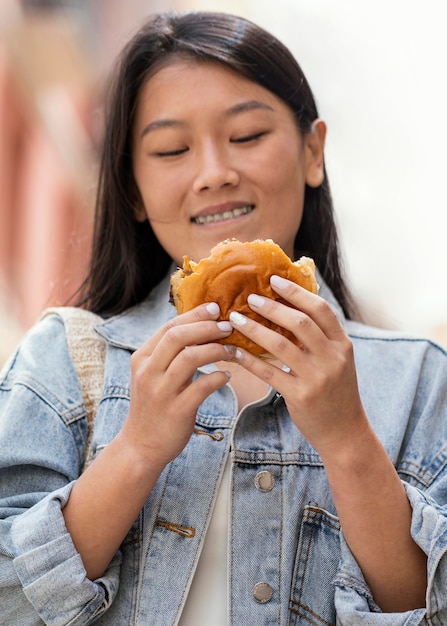 Asian woman being happy after buying street food