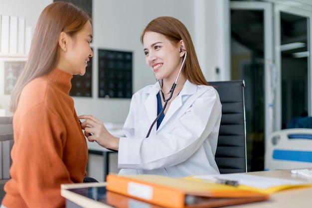 Asian woman doctor Breast cancer Symptoms risk factors and treatment checking for patient in clinic office