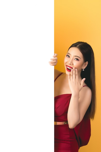 Asian woman holding and looking up to speech bubble with empty space for text