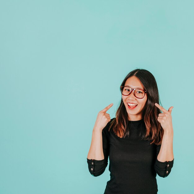 Asian woman pointing at herself