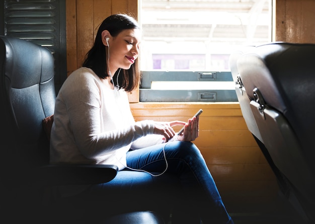 Free photo asian woman riding a train