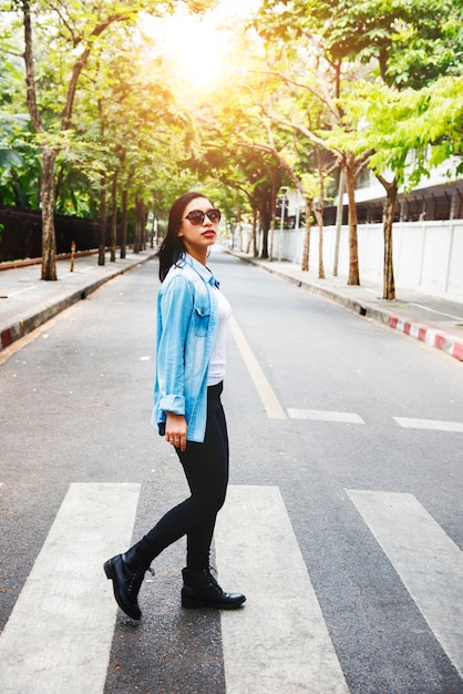 Asian woman walking crossing the road