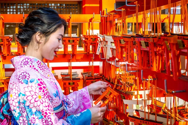 Asian women wearing japanese traditional kimono visiting the beautiful in Fushimi Inari Shrine in Kyoto, Japan