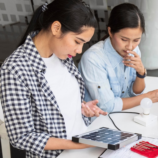 Asian women working hard together for an innovation