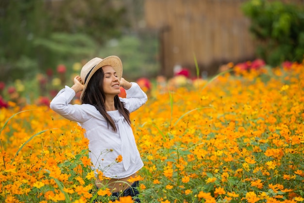 Free photo asian women in yellow flower farm