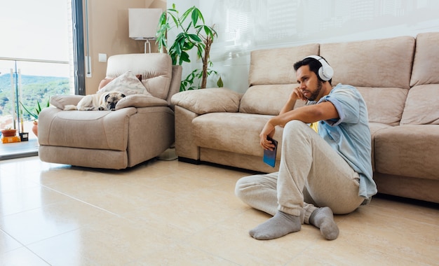 Asian young man with depression sitting on the floor at home