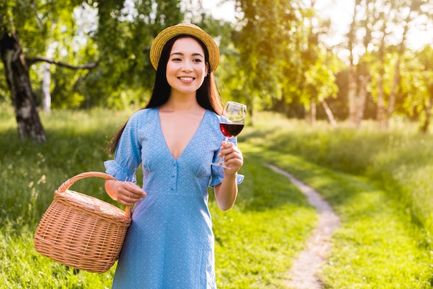 Asian young woman with glass and basket