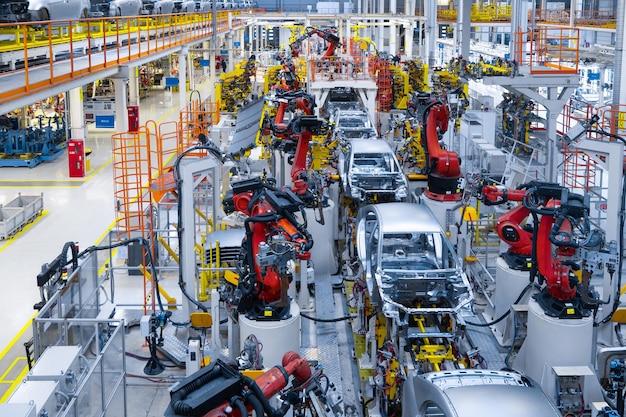 Assembly line production of new car Automated welding of car body on production line robotic arm on car production line is working