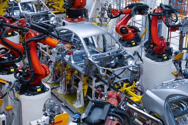 Assembly line production of new car Automated welding of car body on production line robotic arm on car production line is working