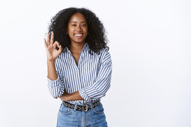 Assertive good-looking confident businesswoman relaxed showing okay ok gesture no problem, assured plan perfect, work done great, standing self-assured satisfied, recommending product