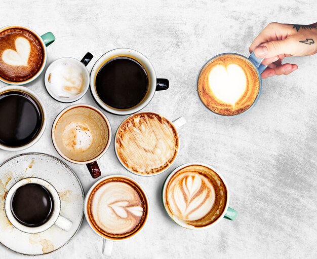 Assorted coffee cups on a textured background