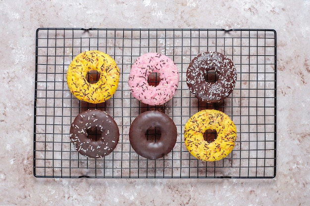 Free Photo assorted donuts with chocolate frosted, pink glazed and sprinkles.