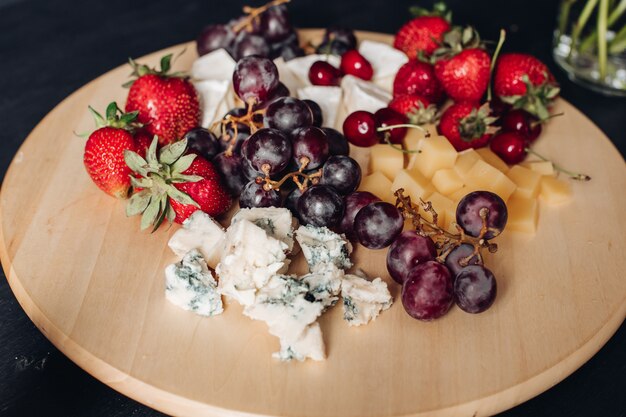 Assorted fruit and cheese plate.Close-up of delicious food plate