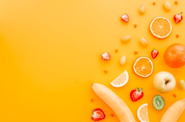 Assorted fruit on yellow background