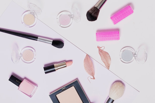 Assorted makeup supplies on light background