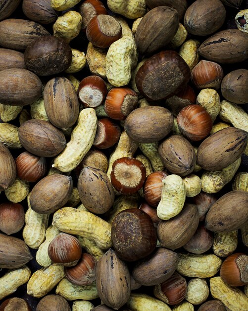 Assorted mixed nuts on wooden table. Top view