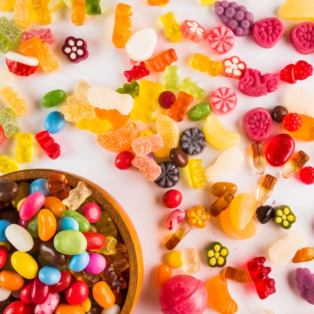 Assorted sweets near bowl with candies