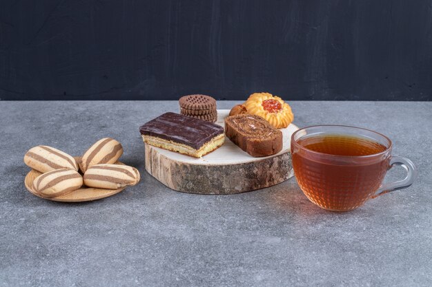 Assortment of cakes and cookies and a cup of tea 