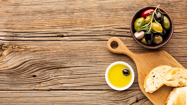 Free photo assortment of colorful olives with oil saucer and copy space