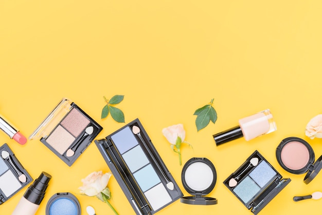 Free Photo assortment of different cosmetics with copy space on yellow background