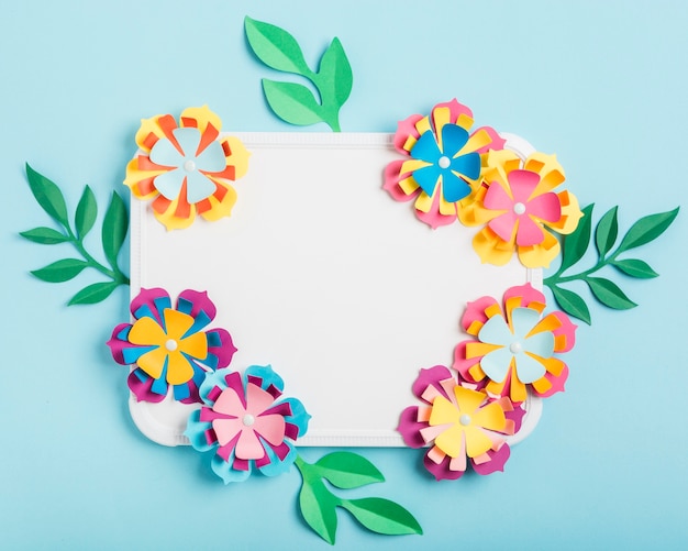 Free photo assortment of multicolored paper spring flowers on whiteboard