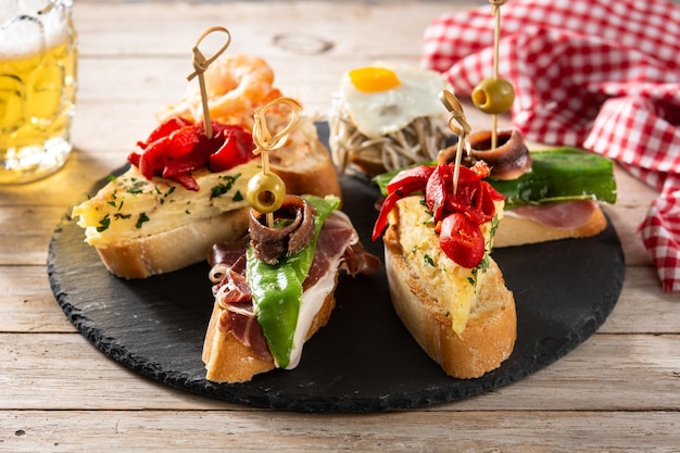 Free photo assortment of spanish pintxos on wooden table typical spanish food