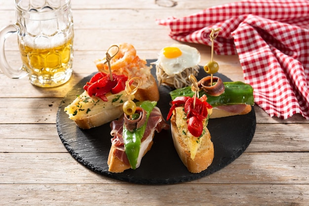 Free Photo assortment of spanish pintxos on wooden table typical spanish food