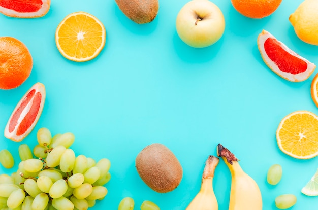 Free photo assortment of tropical fruits on turquoise background