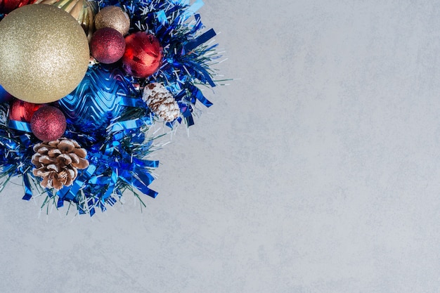 Assortment of various christmas decorations on a wooden board on marble surface