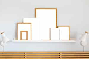 Free photo assortment of white empty frames on table