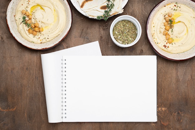 Free photo assortment with delicious local food dish with empty notepad