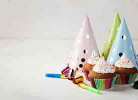 Free photo assortment with glazed muffins and party hats