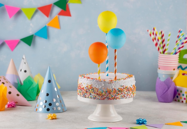 Assortment with tasty cake and balloons