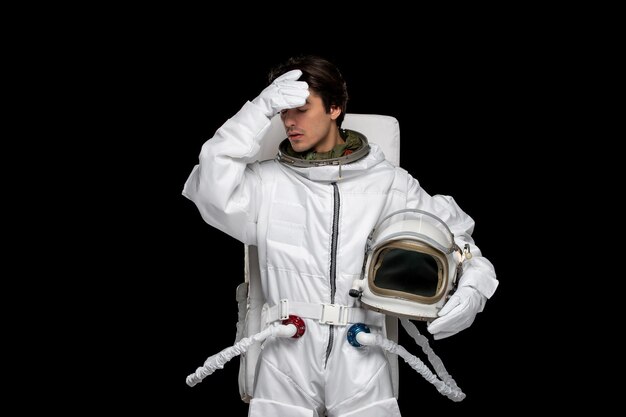 Astronaut day confused spaceman in outer space cosmos galaxy helmet off touching forehead thinking