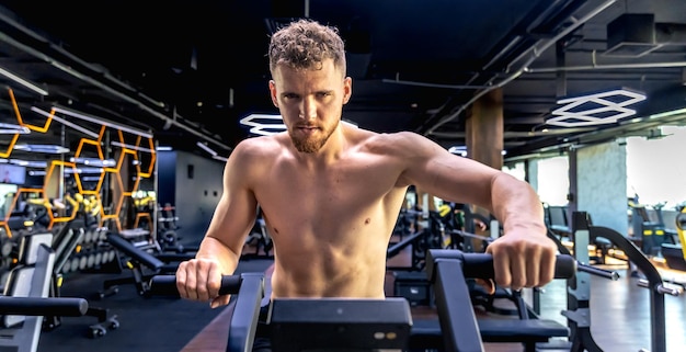 Free Photo athlete doing exercises on an air bike exercise bike closeup