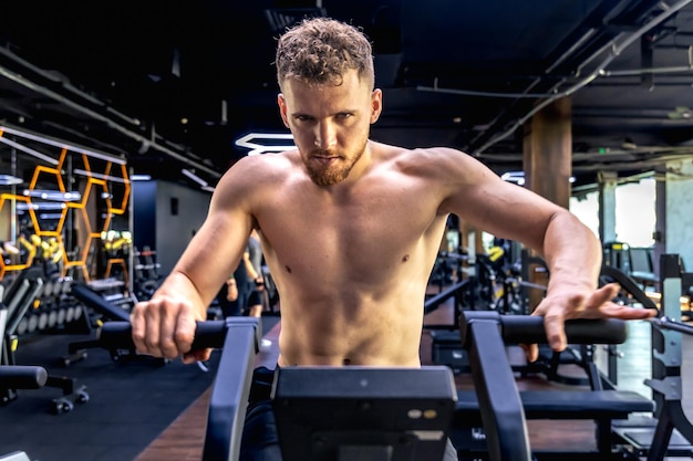 Free Photo athlete doing exercises on an air bike exercise bike closeup