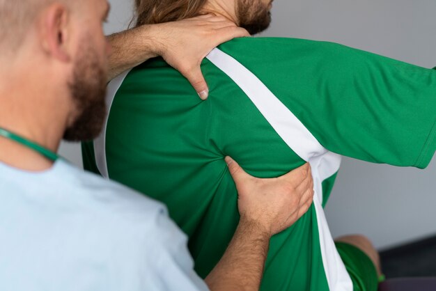 Free Photo athlete doing physiotherapy  side view