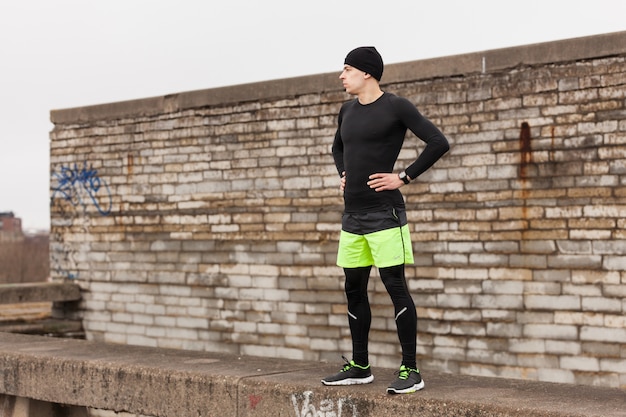 Free photo athlete in front of a wall