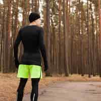 Free photo athlete standing in woods