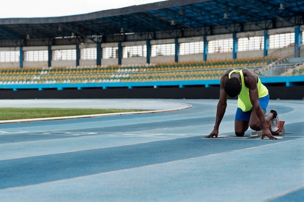 Free Photo athlete on the starting line at the stadium