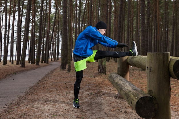 Athlete stretching in forest