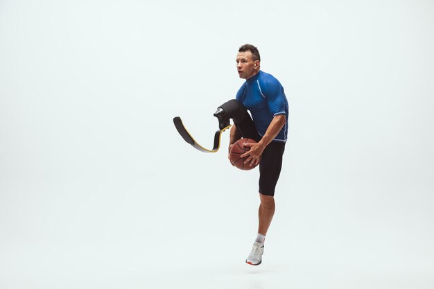 Athlete with disabilities or amputee on white studio, basketball