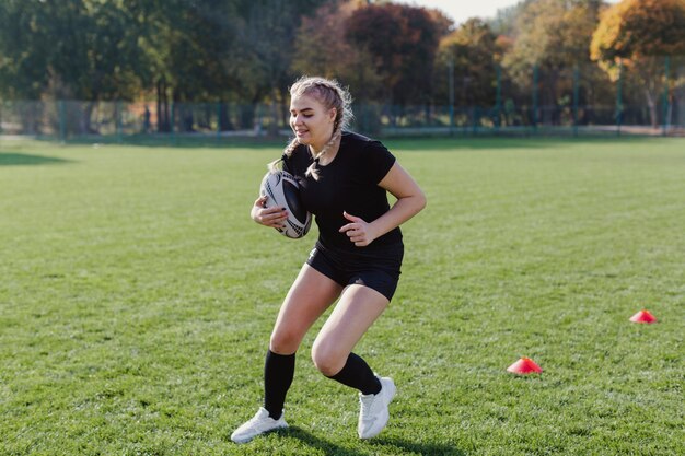 Athletic blonde woman holding a soccer ball