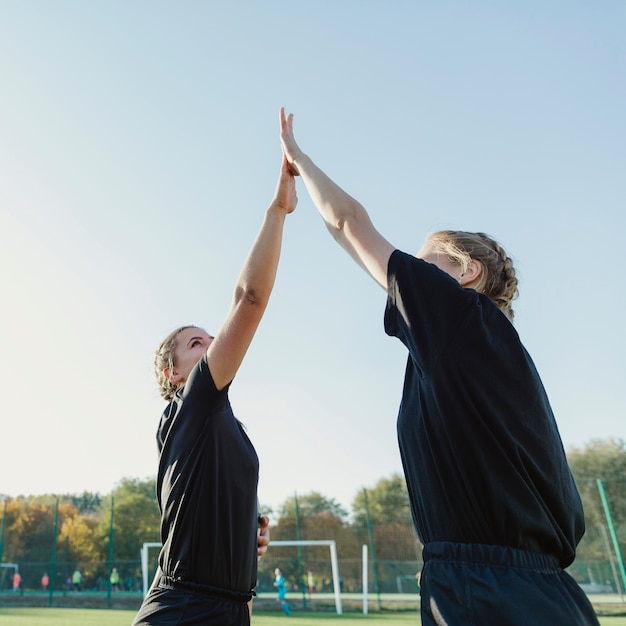 Athletic blonde women high five