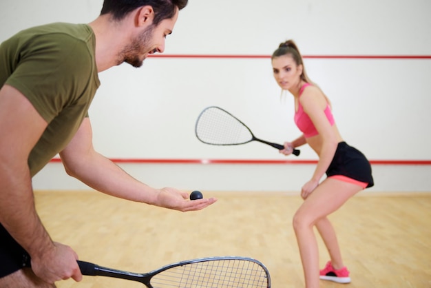 Free photo athletic couple playing squash together