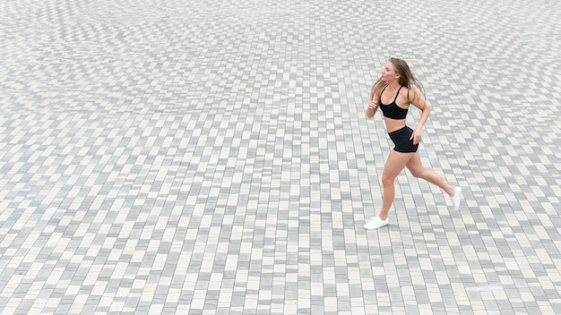 Athletic girl running on the ground