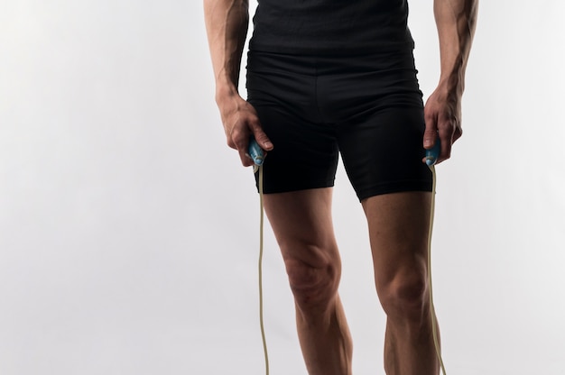 Athletic man holding jumping rope