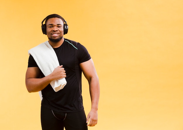 Athletic man posing in gym outfit and towel