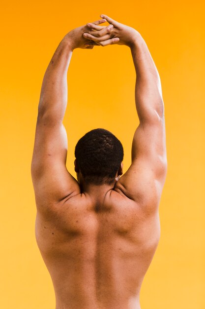 Athletic shirtless man stretching